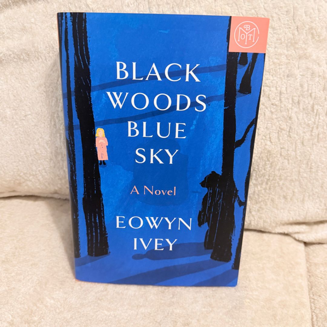 Black woods blue sky