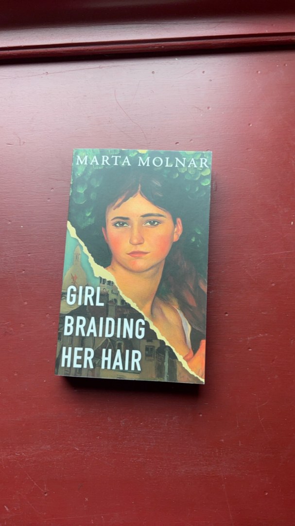 Girl Braiding Her Hair